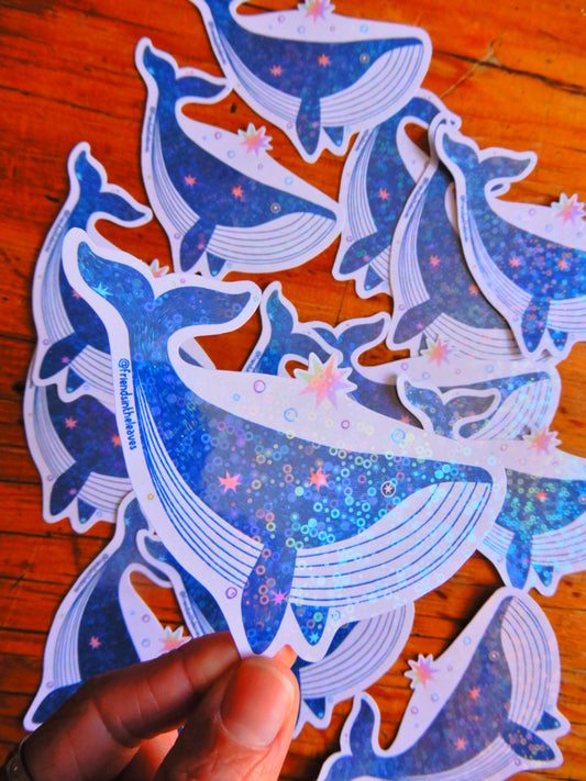 An illustrated holographic whale sticker handmade in Tasmania