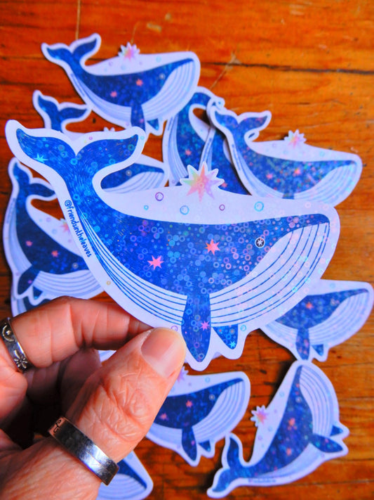 An illustrated holographic whale sticker handmade in Tasmania